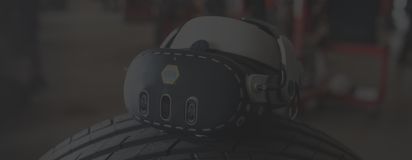 XR Training Goggles resting on a vehicle tire in an automotive workshop