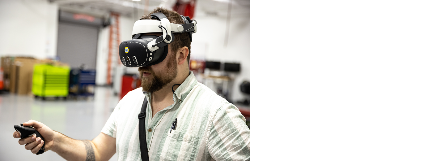 Person wearing a XR Training Goggles and holding a controller during automotive training in a workshop.