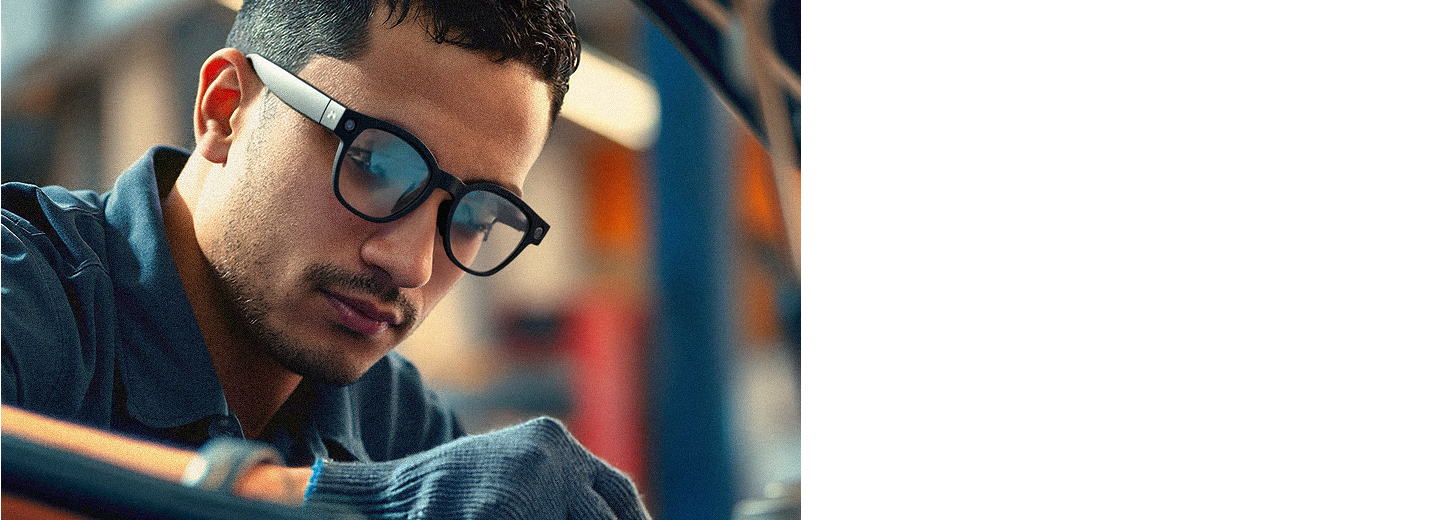 Automotive technician wearing smart glasses and gloves inspecting a vehicle engine in a repair shop.